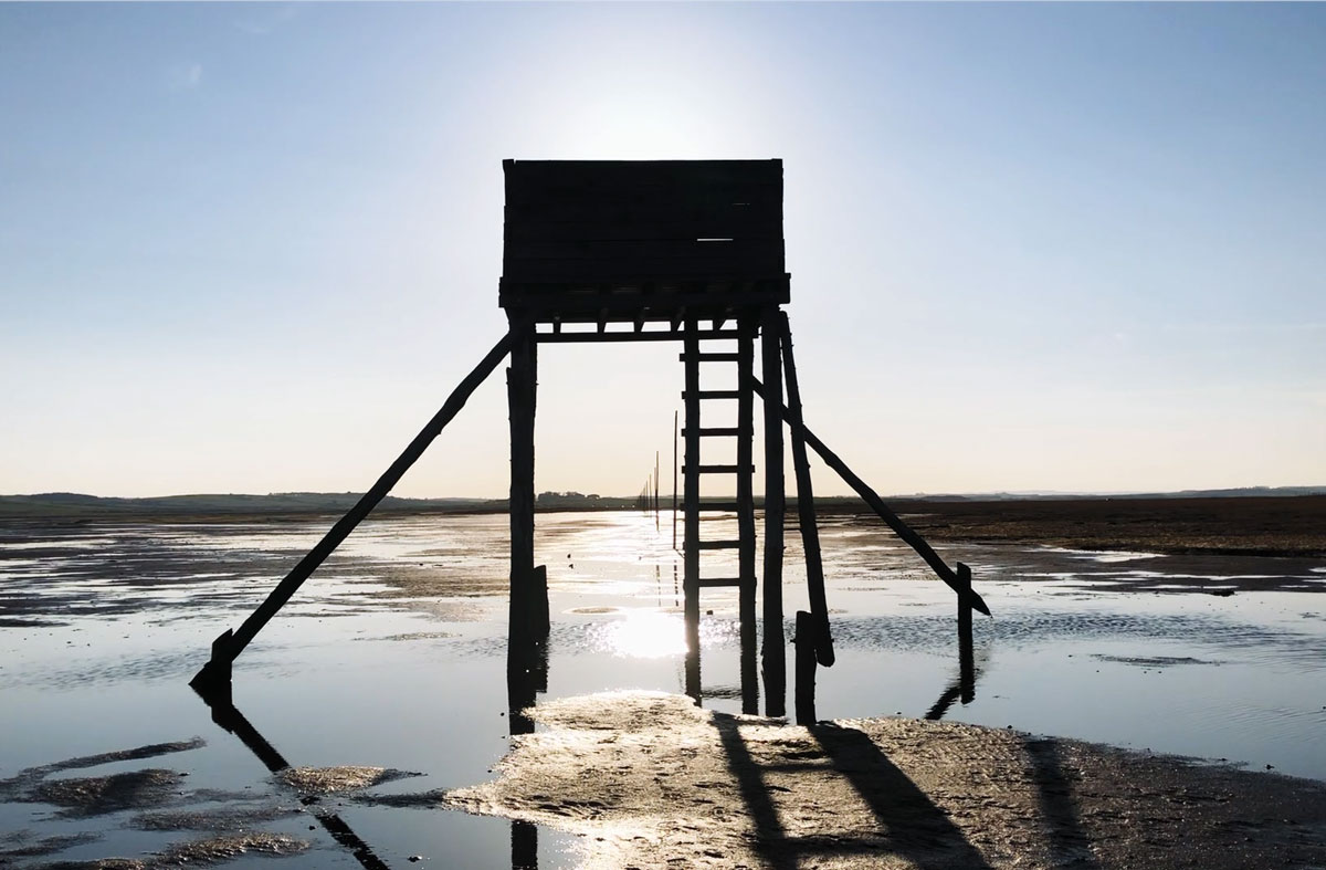 A silhouette of refuge tower on the Pilgrim's Way in Lindisfarne.