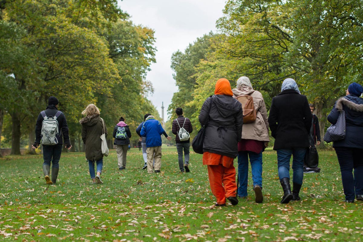 A group walking in the natural setting of Gibside National Trust Site.